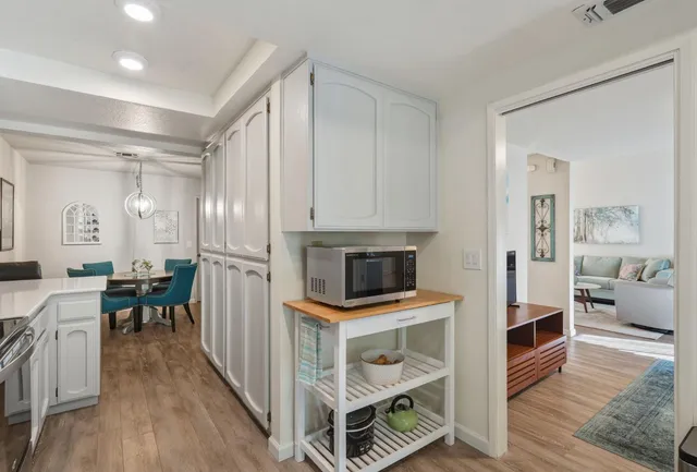 a view of kitchen with sink and refrigerator