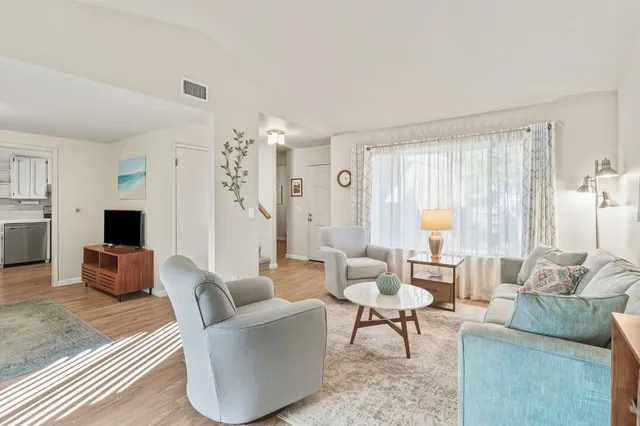 a living room with furniture and a large window