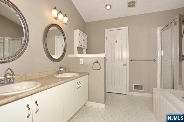 387 Green Mountain Road Mahwah, NJ 07430 - Photo 14 of 25 a bathroom with a granite countertop sink a mirror and a shower