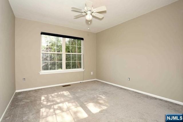 387 Green Mountain Road Mahwah, NJ 07430 - Photo 15 of 25 a view of a big room with windows and chandelier fan