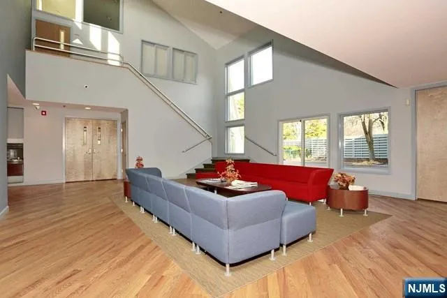 a living room with furniture and a floor to ceiling window
