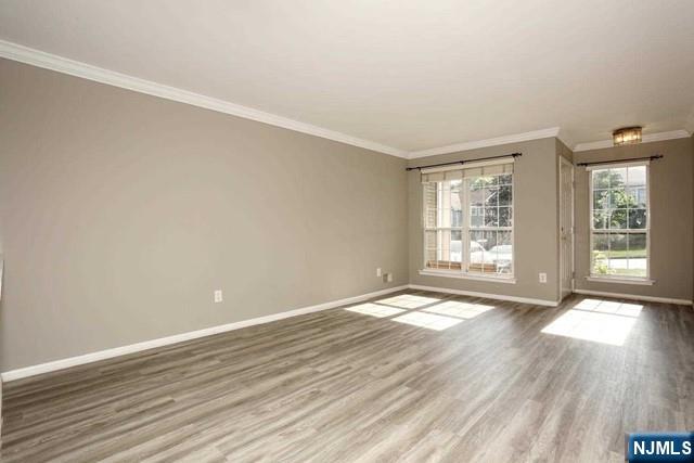 387 Green Mountain Road Mahwah, NJ 07430 - Photo 3 of 25 a view of an empty room with wooden floor and a window