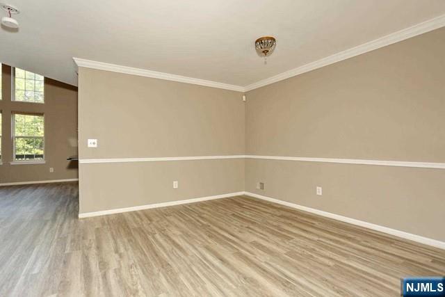 387 Green Mountain Road Mahwah, NJ 07430 - Photo 5 of 25 a view of an empty room with window and wooden floor