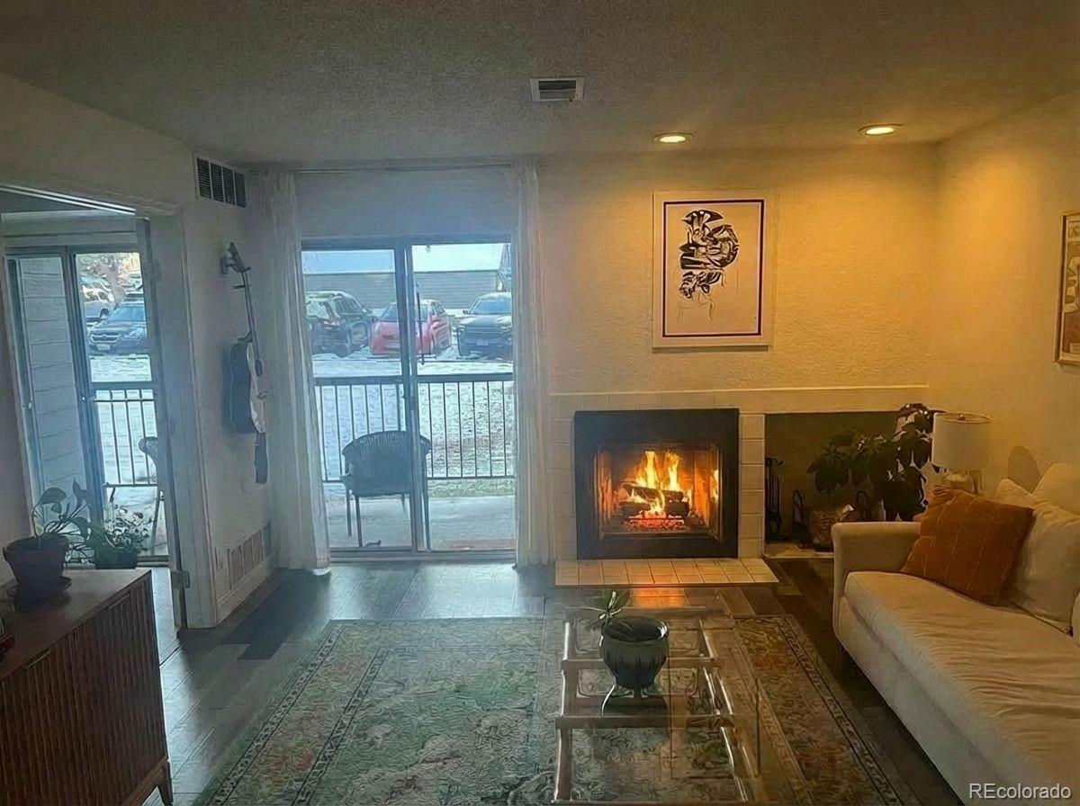 2575 South Syracuse Way, Unit D103 Denver, CO 80231 - Photo 3 of 10 a living room with furniture and a fireplace