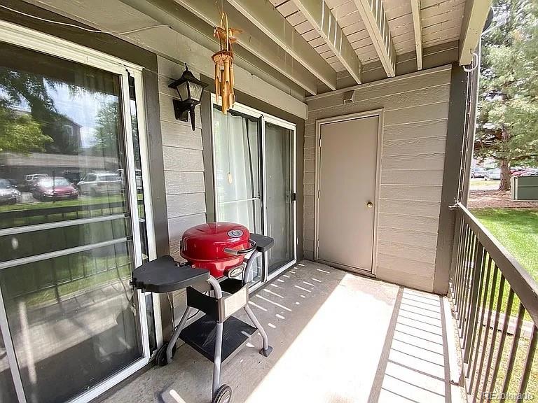 2575 South Syracuse Way, Unit D103 Denver, CO 80231 - Photo 7 of 10 a balcony with table and chairs