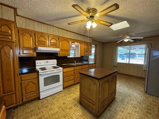 a kitchen with stainless steel appliances granite countertop a stove and a refrigerator