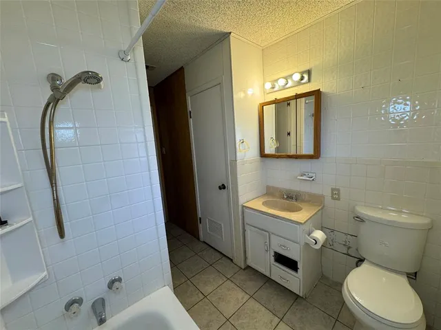 a spacious bathroom with a toilet sink and mirror