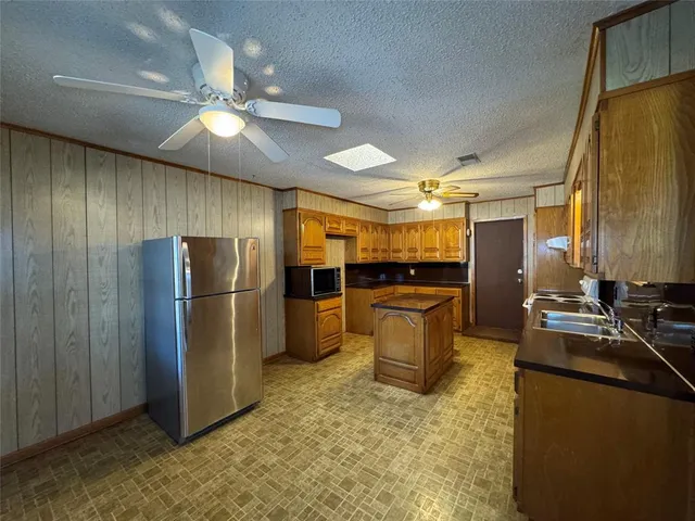 a kitchen with refrigerator and cabinets
