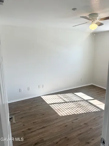 a view of hallway with wooden floor