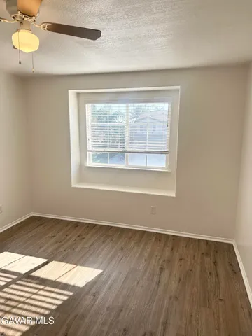 an empty room with wooden floor