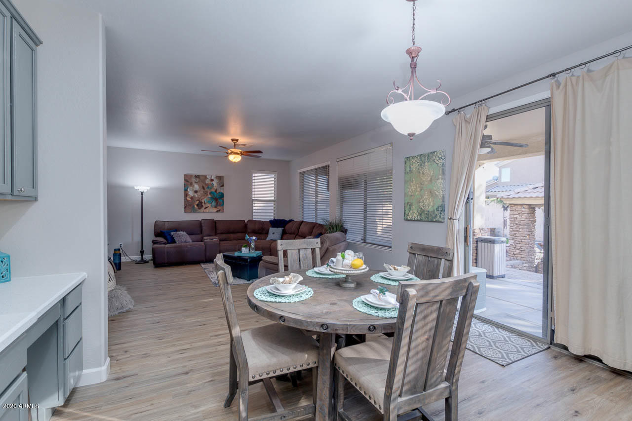 3315 East Los Altos Road Gilbert, AZ 85297 - Photo 19 of 66 a view of a dining room with furniture window and wooden floor