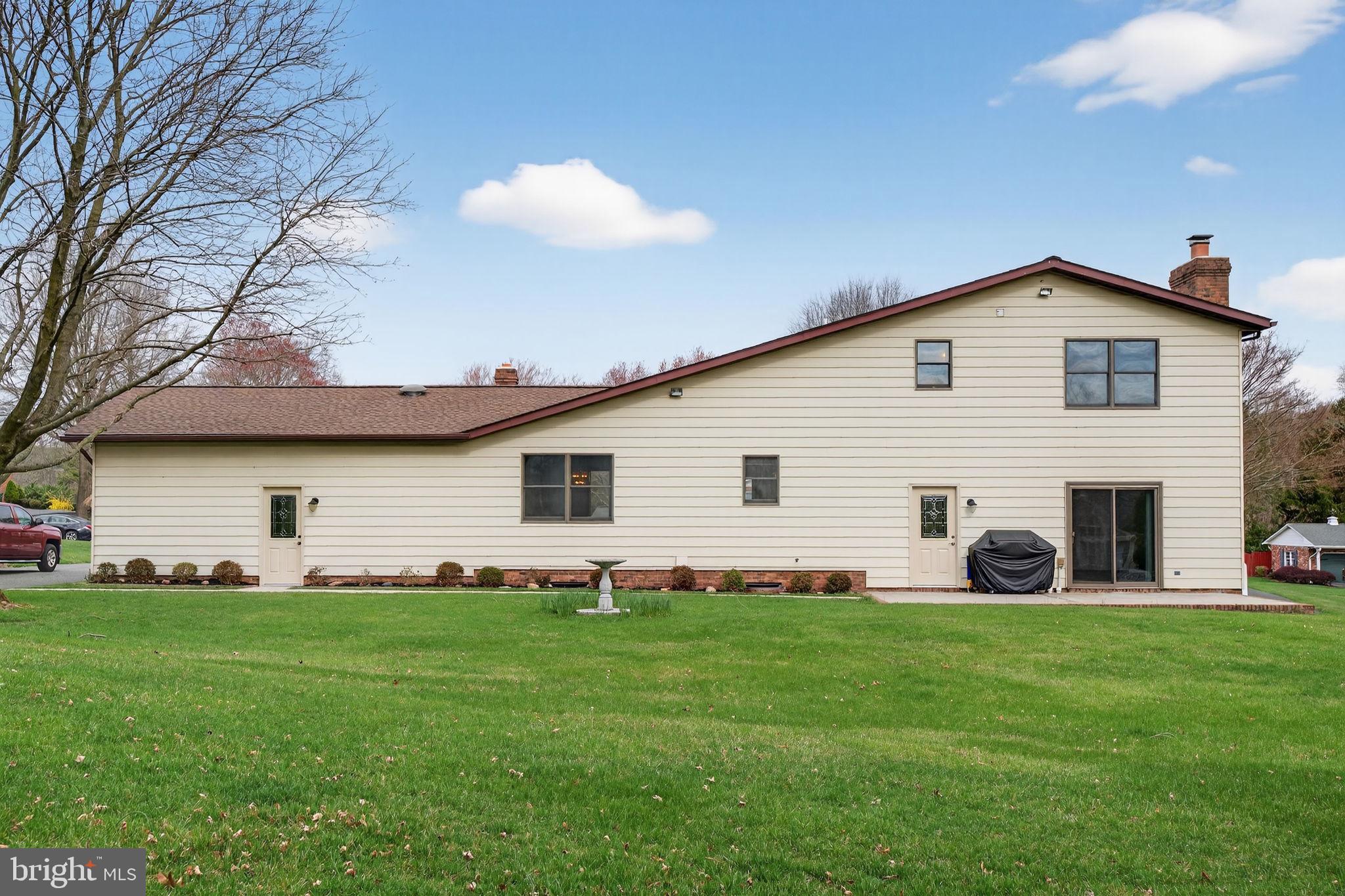 1703 Brickhouse Lane Fallston, MD 21047 - Photo 6 of 43 a front view of a house with a yard and trees