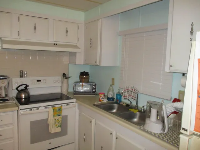 a kitchen with a sink and cabinets