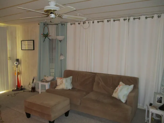 a living room with a couch and a chandelier