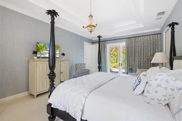 a bedroom with a bed dresser and a window