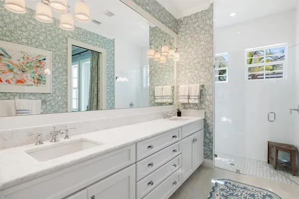 a bathroom with a double vanity sink and a mirror