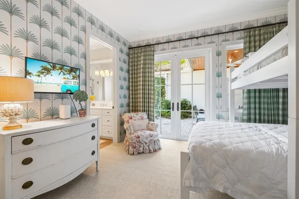 a spacious bedroom with a bed and a large window