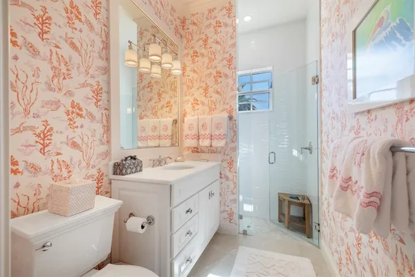 a bathroom with a sink toilet and shower
