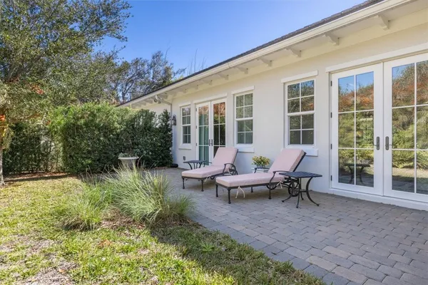 a view of a house with backyard sitting area and garden