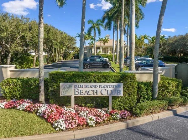 a view of a sign board with flower plants