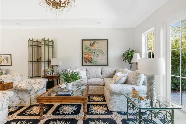 a living room with furniture and large windows