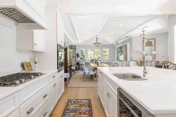 a kitchen with a sink stove and cabinets