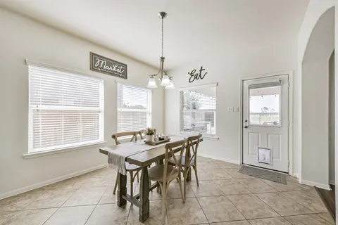 a dining room with furniture and window