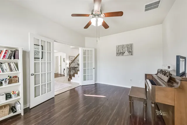 a view of a livingroom with furniture wooden floor chandelier fan