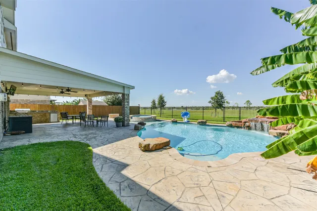a view of a backyard with swimming pool