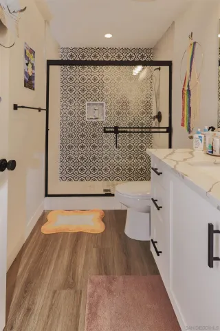 a bathroom with a shower toilet and a sink