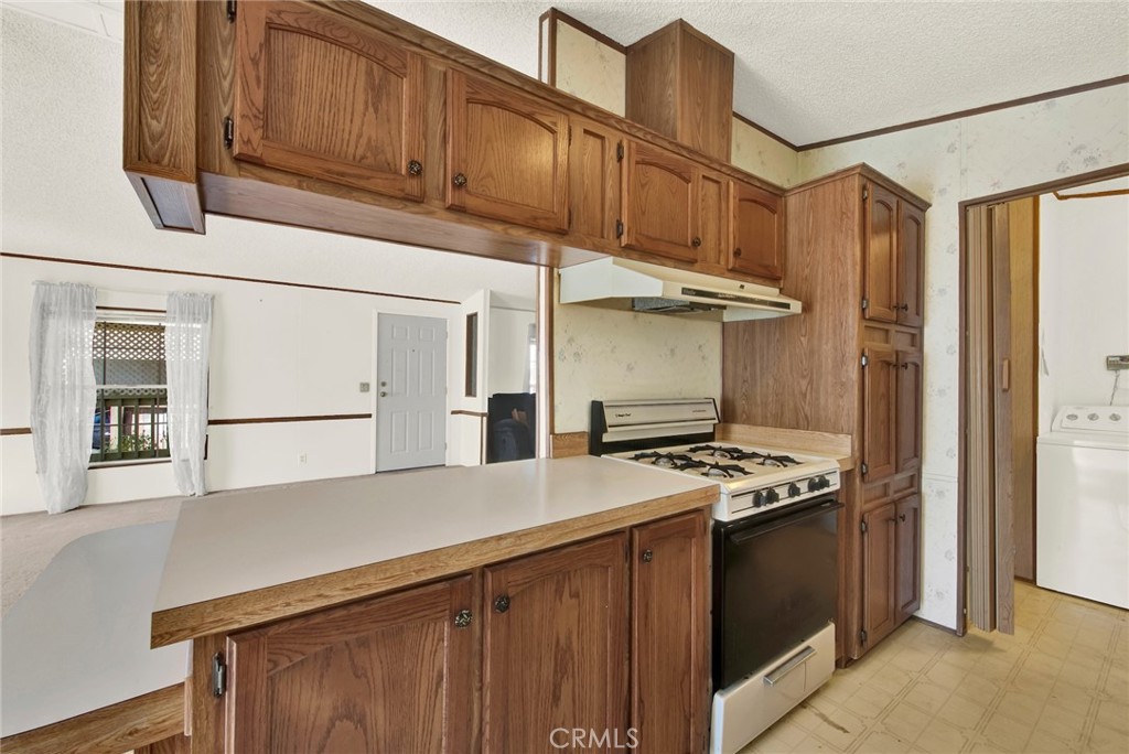3835 Gardiner Ferry Road, Unit 31 Corning, CA 96021 - Photo 12 of 58 a kitchen with stainless steel appliances granite countertop a refrigerator and a stove top oven