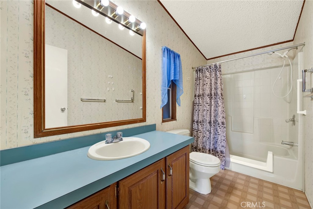 3835 Gardiner Ferry Road, Unit 31 Corning, CA 96021 - Photo 29 of 58 a bathroom with a sink a toilet a mirror and shower