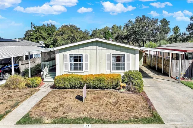 a front view of a house with a yard and potted plants