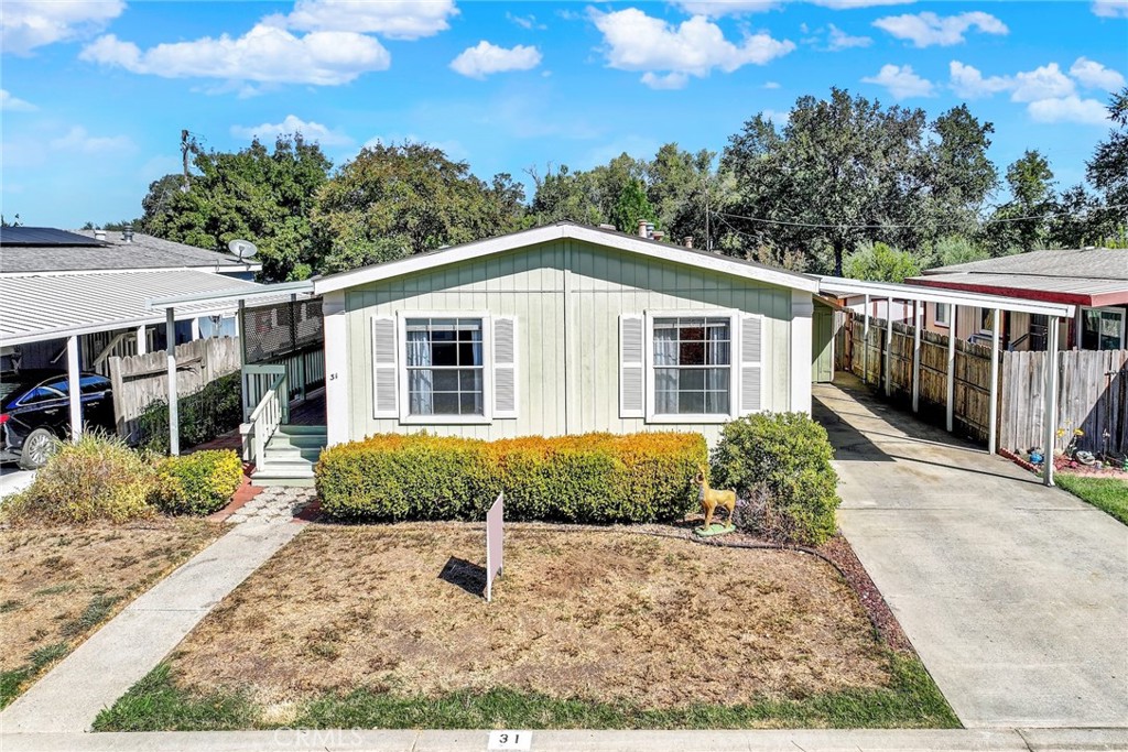 3835 Gardiner Ferry Road, Unit 31 Corning, CA 96021 - Photo 3 of 58 a front view of a house with a yard and potted plants