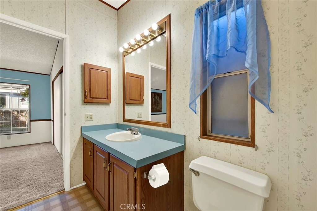 3835 Gardiner Ferry Road, Unit 31 Corning, CA 96021 - Photo 58 of 58 a bathroom with a toilet a sink and mirror