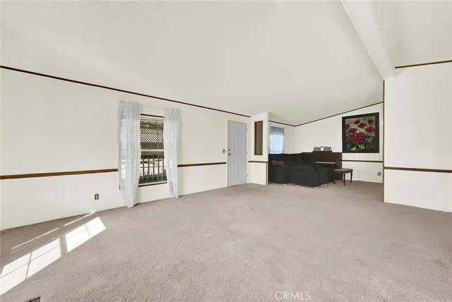 a view of livingroom with furniture and white refrigerator