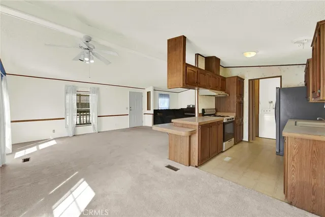 a kitchen with a refrigerator and a stove top oven