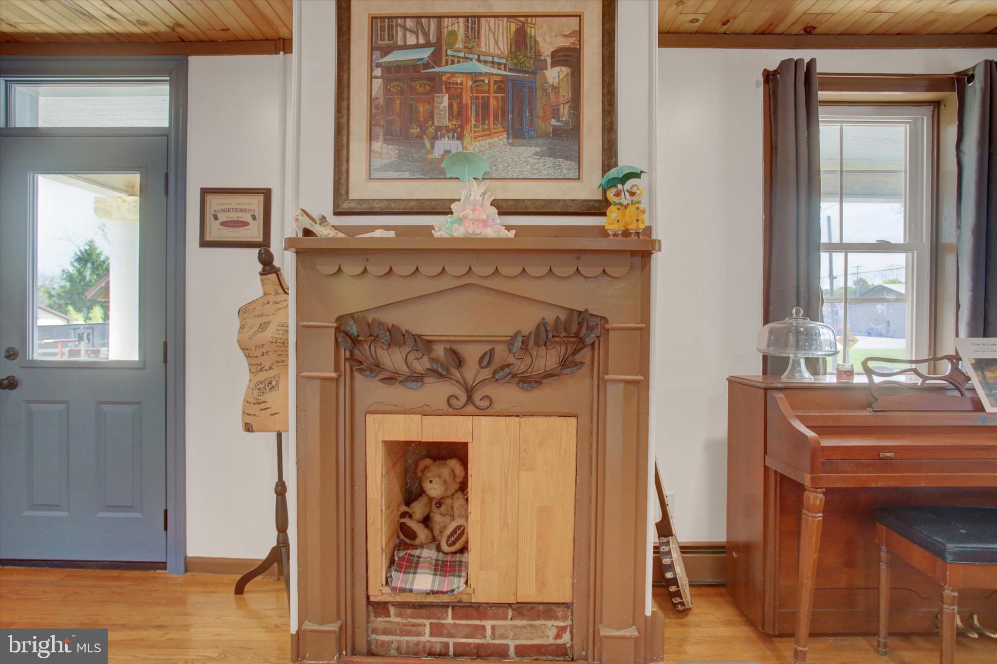 9775 Upper Strasburg Road Upperstrasburg, PA 17265 - Photo 11 of 35 a living room with a fireplace and a window