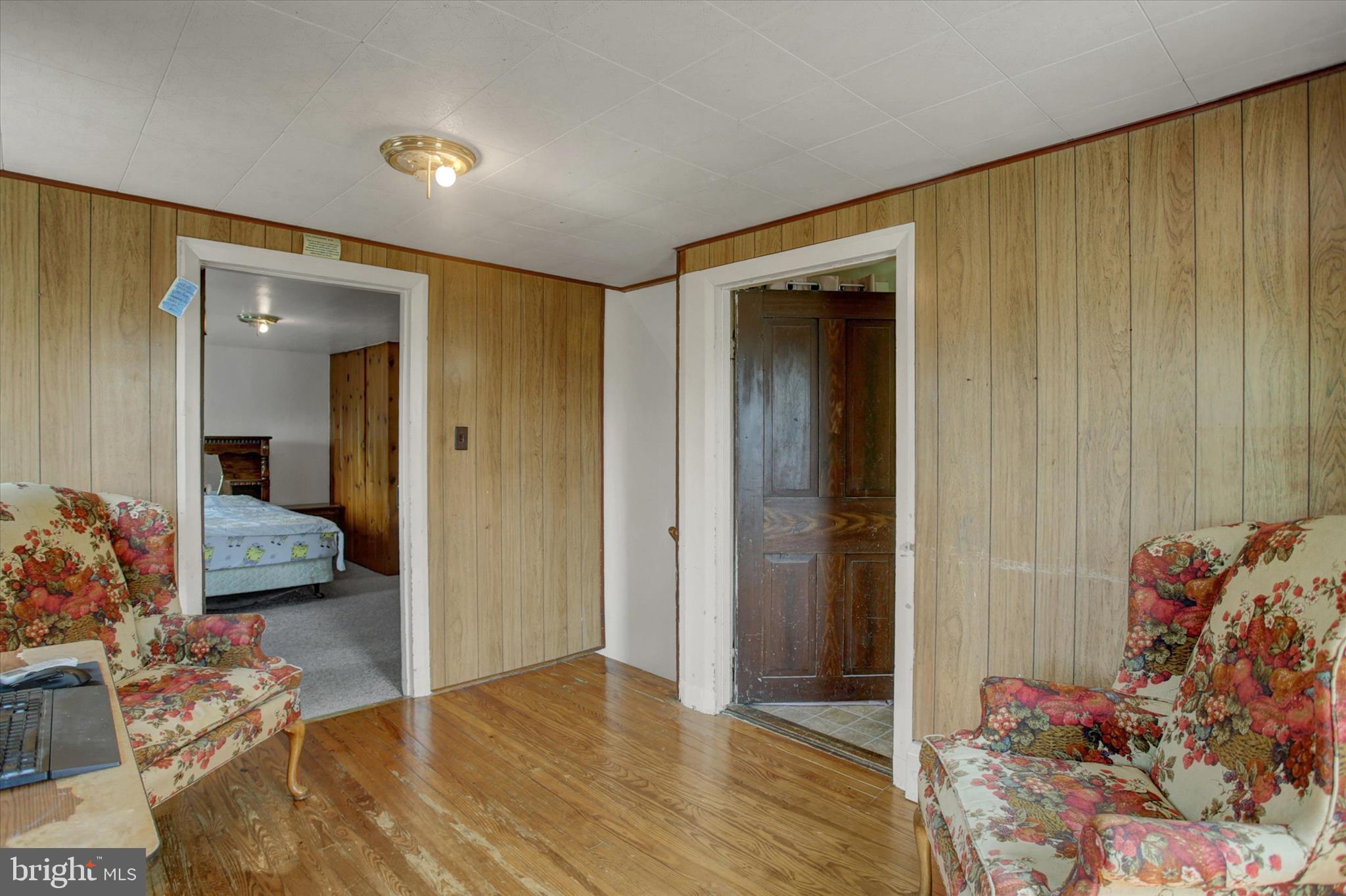9775 Upper Strasburg Road Upperstrasburg, PA 17265 - Photo 22 of 35 a view of a livingroom with wooden floor and a bedroom