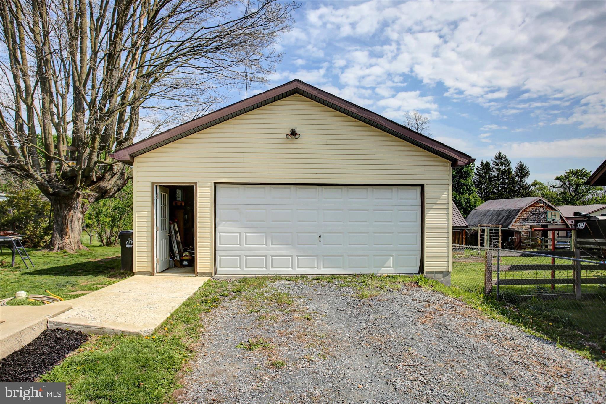 9775 Upper Strasburg Road Upperstrasburg, PA 17265 - Photo 29 of 35 a front view of a house with a yard and garage