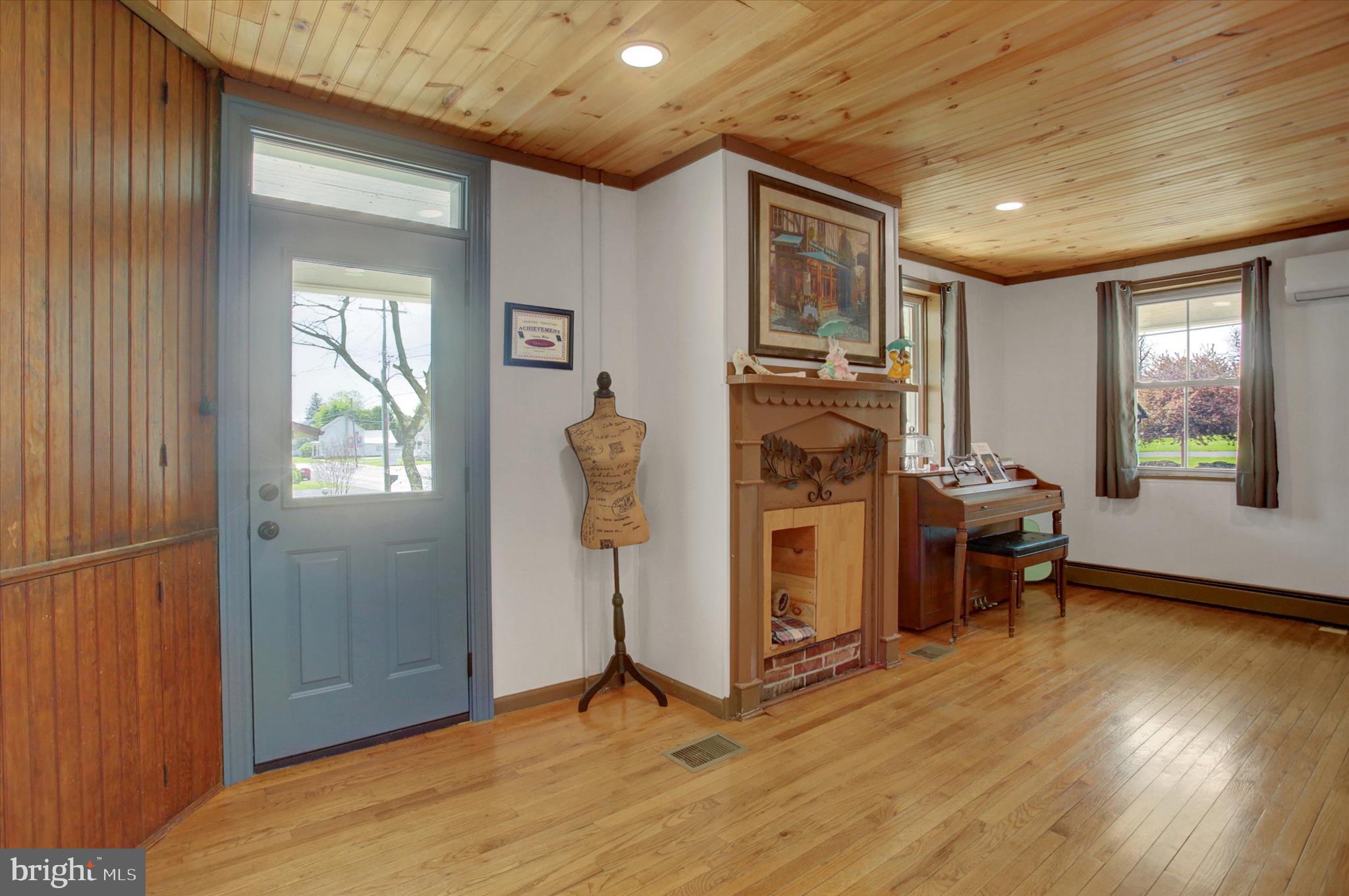 9775 Upper Strasburg Road Upperstrasburg, PA 17265 - Photo 6 of 35 a view of a livingroom with furniture hardwood floor and a ceiling fan