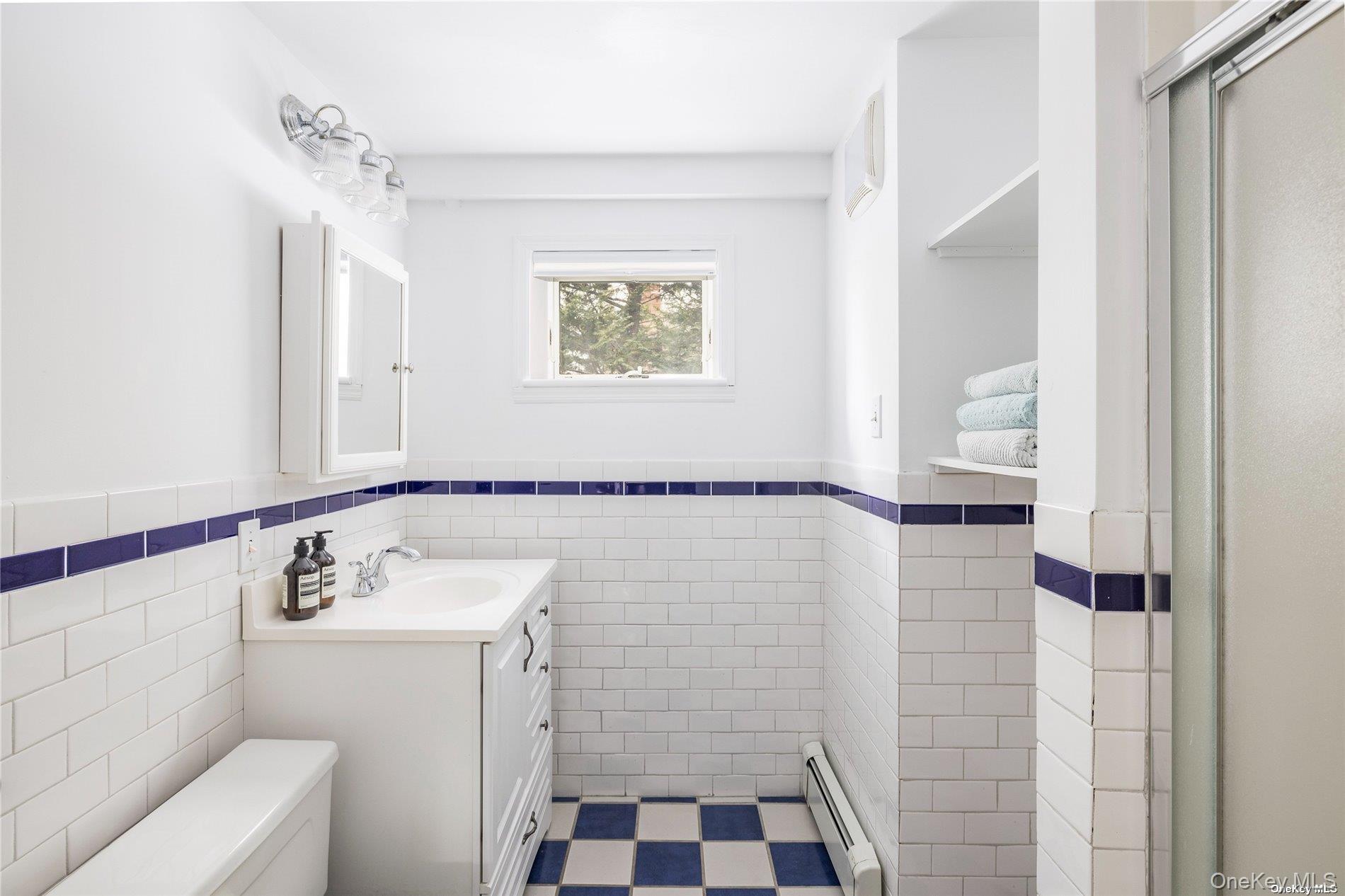 17 B Baycrest Avenue Westhampton, NY 11977 - Photo 16 of 22 a bathroom with a sink a toilet and shower