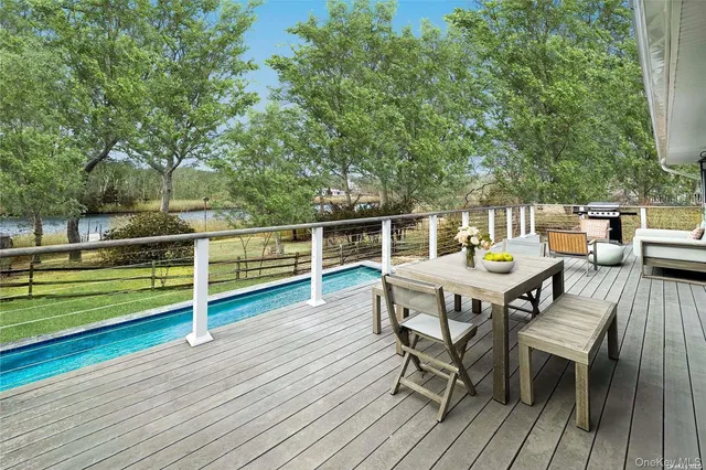 a view of a chairs and table on the wooden deck