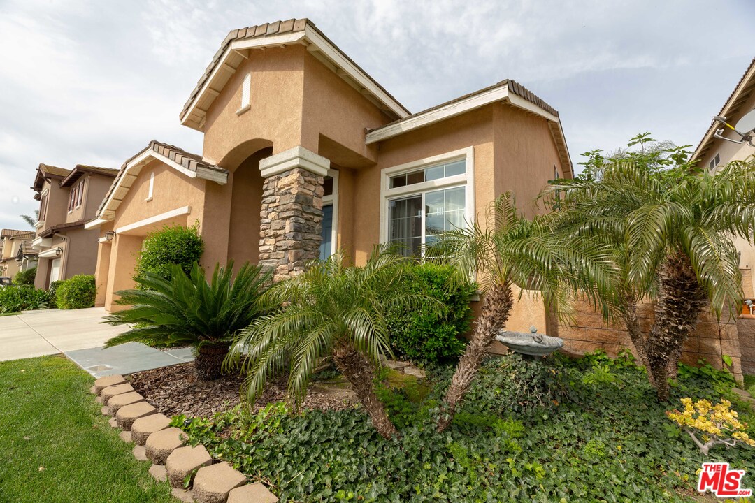 6837 Raspberry Court Eastvale, CA 92880 - Photo 3 of 41 a front view of a house with a yard