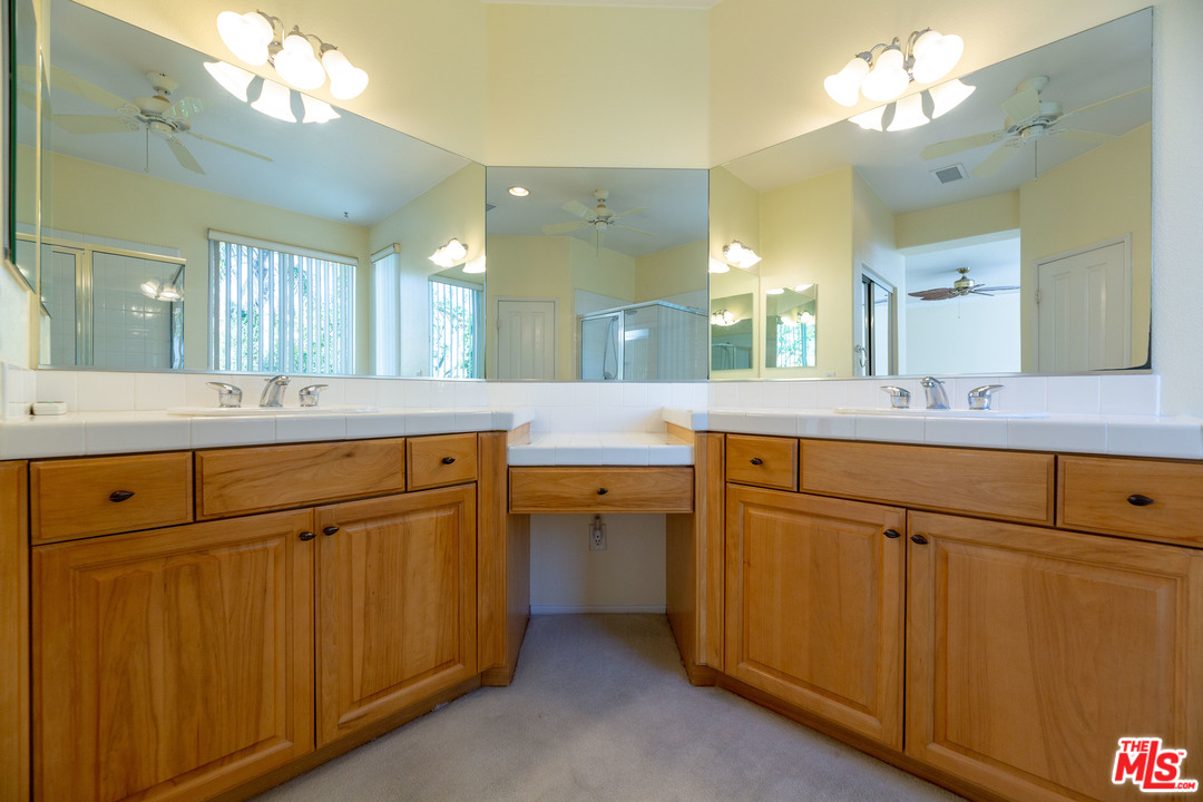 6837 Raspberry Court Eastvale, CA 92880 - Photo 22 of 41 a bathroom with a sink vanity and mirror