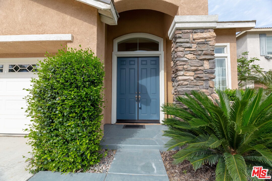 6837 Raspberry Court Eastvale, CA 92880 - Photo 4 of 41 a front view of a house with a yard