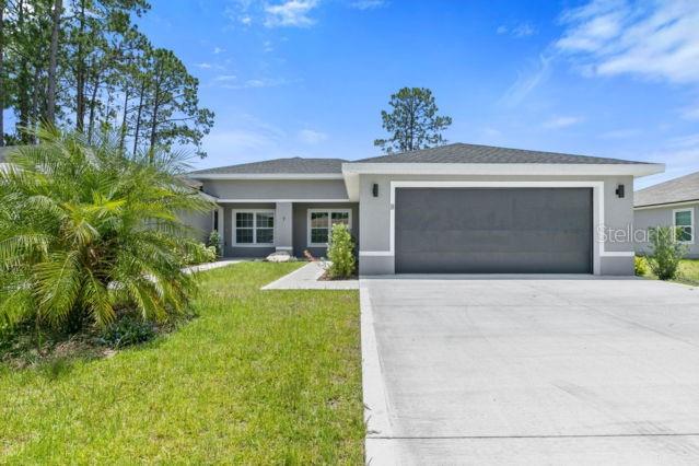 7 Regis Lane, Unit B Palm Coast, FL 32164 - Photo 1 of 1 a front view of a house with garden