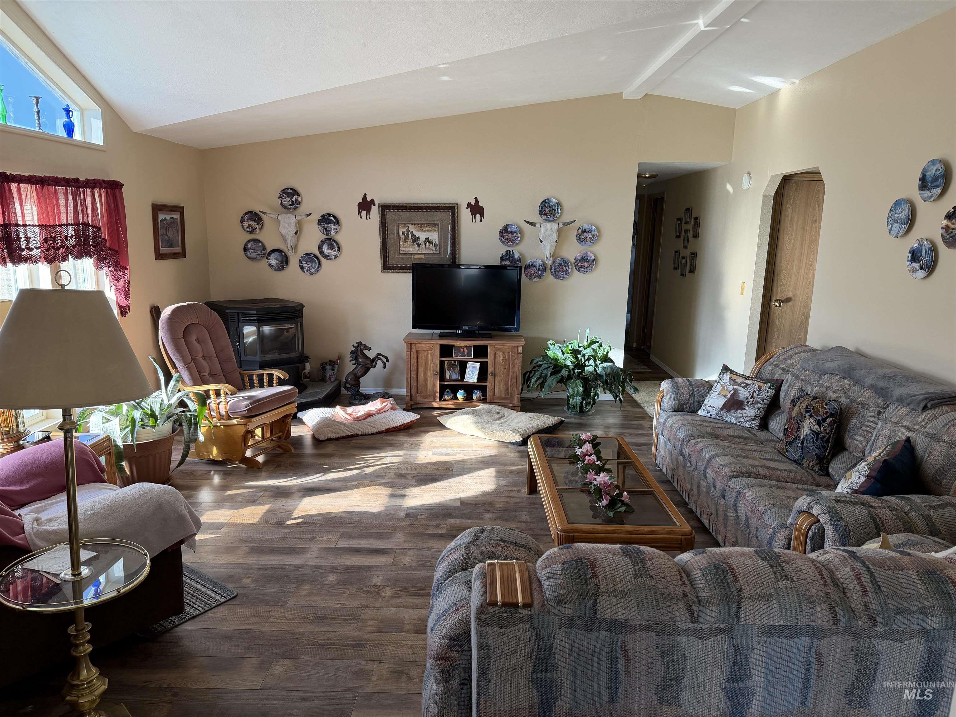 13648 Highway 44 Caldwell, ID 83607 - Photo 6 of 8 Living room with a wood stove, wood-type flooring, and arched walkways