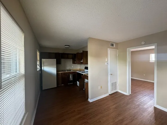 a kitchen with a refrigerator sink and cabinets