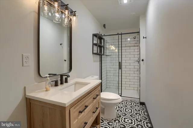 a bathroom with a sink toilet and shower